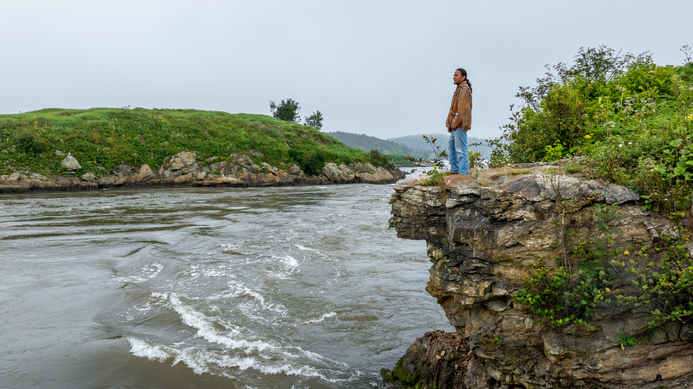 Man standing on hill overlooking reversing falls