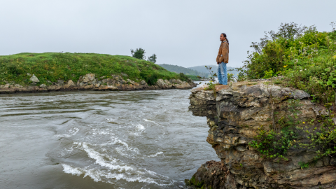 Man standing on hill overlooking reversing falls
